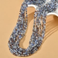 Detail shot of 3mm faceted blue and brown crystal beads on a professional beige display - Blue AB