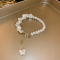 Detail of elegant pearl bracelet with golden butterfly pendant on a gold tray - 2# Bracelet-White Pearl-Butterfly