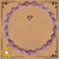 Dettaglio del bracciale di perline in diaspro zebra rosa con ciondolo a girasole smaltato - Bracciale con trama venatura del legno rosso