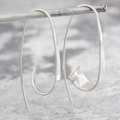 Gypsy spiral curved silver hoop earrings with polished geometric long hook design - Silver
