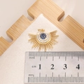 Detailed scale measurement of a golden sunburst evil eye pendant with blue zircon - E006G