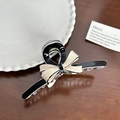 Elegant black and beige bow hair claw clip with transparent base on a wooden desk - Black Base Ribbon Medium-11cm