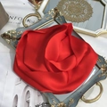 Close-up of a red pure silk scarf folded into a rose shape on a vintage tray - 15x150cm / Red