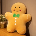 Gingerbread man plush pillow in golden brown with green bowtie for Christmas decor - Smiling Gingerbread Man