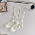 Minimalist white mid-calf cotton socks with ribbed texture in a flat lay style - Ivory