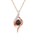 Macro shot of rose gold necklace featuring small pavé zircons and a black projection stone - Irregular Shape Rose Gold