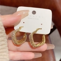 Close-up of gold twisted hoop earrings with pave-set rhinestones on a display card - Twisted Geometric Pave Zirconia (E2132 Gold) / 925 Silver Needle / Gold
