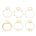 6er-Set goldene Bohemian-Armbänder mit Herz, Quaste und weißen Perlen auf weißem Grund - Gold Quaste Lila Blume Set (0111)