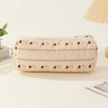 Detail of floral embroidery and quilted cotton texture on a beige travel storage bag - Striped Flowers