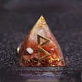 Orgone pyramid with red crystal stones and golden rune symbol for desktop decor - Birth - New Beginning & Fertility