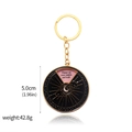 Macro shot of 5cm gold spinning keychain showing weight and dimensions for product detail - Inner Wisdom Keychain