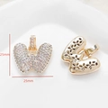 Detailed view of a 25mm gold butterfly pendant with cubic zirconia and floral hollow back - Letter W