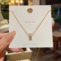 Elegante collana in acciaio al titanio dorato con pendente cilindrico con cristalli incastonati - Stile Cilindro con Zirconia (X369) / Oro