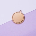 Polished rose gold stainless steel round pendant with a rope textured edge on modern backdrop - Rose Gold (25MM)