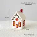 White ceramic light-up Christmas house with red chimney and green wreath details - Lace Forest House A