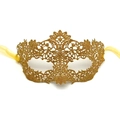 Close-up of golden lace masquerade mask with intricate hollow patterns and silk ribbons - One Size / Gold Thread