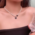 Elegant pearl necklace with a black heart pendant and silver clasp worn on neck - 5761482237577 / Black Heart Pearl Beaded Necklace (DX0264) / Black/White