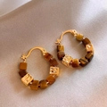 Detailed shot of gold hoop earrings with brown square stones and face-embossed metal beads - Gold Coffee Face Relief (Genuine Gold Plated)