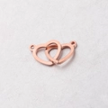 Dettaglio dei connettori a cuore intrecciati in oro rosa per gioielli fai-da-te 12x20mm - Oro rosa