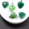 Set of five heart-shaped green stone pendants with silver clasps on a white display - Green Agate