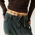 Detailed close-up of retro gold metal waist chain with geometric relief on denim jeans - Gold Retro Metal Oval Waist Chain