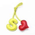 Handmade leather bag charm featuring a yellow letter S and red heart with stitch detail - Light Yellow with Bright Red Heart