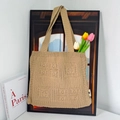 Detail of khaki knitted tote bag with Have a Nice Time pattern and tulip decoration - Caramel color