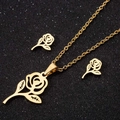 Elegant gold hollow rose pendant necklace and earrings set on a sparkling black background - Rose / Gold