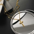 Three-layer titanium steel cross necklace in gold finish on reflective surface - Gold