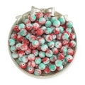 Close-up of red and green marbled round beads in a decorative silver display tray - Snowflake Porcelain Bead - Red Green