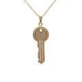 Gold-plated key pendant necklace with sparkling cubic zirconia on a white background - Key