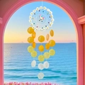 DIY shell wind chime with white unicorn and gradient orange shells hanging in a window - Finished Product / Rainbow Horse Summer-Orange