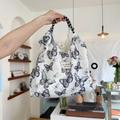 White canvas tote bag featuring black butterfly prints and frayed edges with tassel texture - Lace Butterfly Black