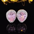 Detailed view of pink pear-shaped stud earrings with halo setting on reflective black surface - Pear Pink Style (E655)