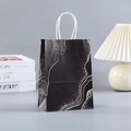 Elegant black marble gift bag with gold fluid patterns and white paper handles on a desk - Black Marble Pattern (Large Size) (34-2)