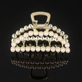 Detail shot of golden metal hair claw with rows of white pearls on black mirror - Gold Full Pearl Large Moon Claw Clip