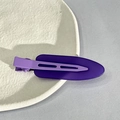 Detail of matte purple seamless hair clips displayed on an aesthetic ceramic plate - Purple