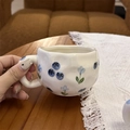 Hand-painted ceramic coffee mug featuring blue berry and flower patterns in a lifestyle setting - Blue Flower Blueberry