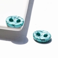 Macro shot of oval turquoise buttons with natural black vein patterns and dual holes - 10*14*4mm / Synthetic Blue Turquoise
