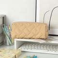 Detail of light khaki quilted geometry pencil case featuring a smooth metal zipper - Light Coffee
