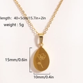 Detail view of a gold teardrop pendant with floral engraving and specific size measurements - Gold