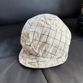 Detailed close-up of beige linen plaid beret hat texture on a dark leather surface - M (56-58cm) / Beige