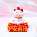 White lucky cat figurine with red apple and cushion base featuring gold characters - 8046 Peace & Joy Cat