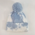 Détail du bonnet en tricot tie-dye avec grand pompon en fourrure et texture côtelée - Bleu clair