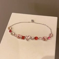Close-up of heart-shaped pink and red zircon stones on a silver-tone link bracelet - 18# Bracelet - Pink - Heart