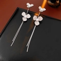 Detailed view of silver flower tassel earrings with shimmering pearls and sparkling rhinestones - Silver (Silver Pin)