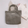 Detailed texture of gray corduroy tote bag with simple wish label on white surface - Gray