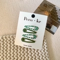 Set of four green floral and checkered snap hair clips on a white card display - Style 17-Green Checkerboard