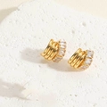 Macro detail of gold-plated hoop earrings with rectangular baguette zircon stones - ES2388-3 Gold Triple-Layer Wrapped Zircon Earrings
