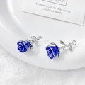 Detailed view of two blue rose charms with silver metal stems on a ceramic plate - Large Blue Rose / #9 Single Price